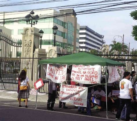 holy angel university scandal|Teachers, workers at Angeles University go on strike.